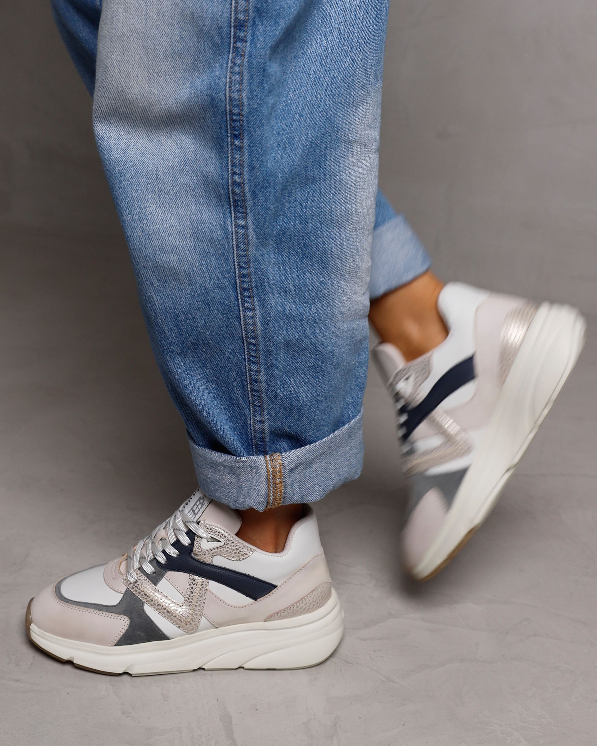 Leren VIA VAI dames sneaker beige, grijs en donkerblauw Vic Kyro, gedragen aan de voet.